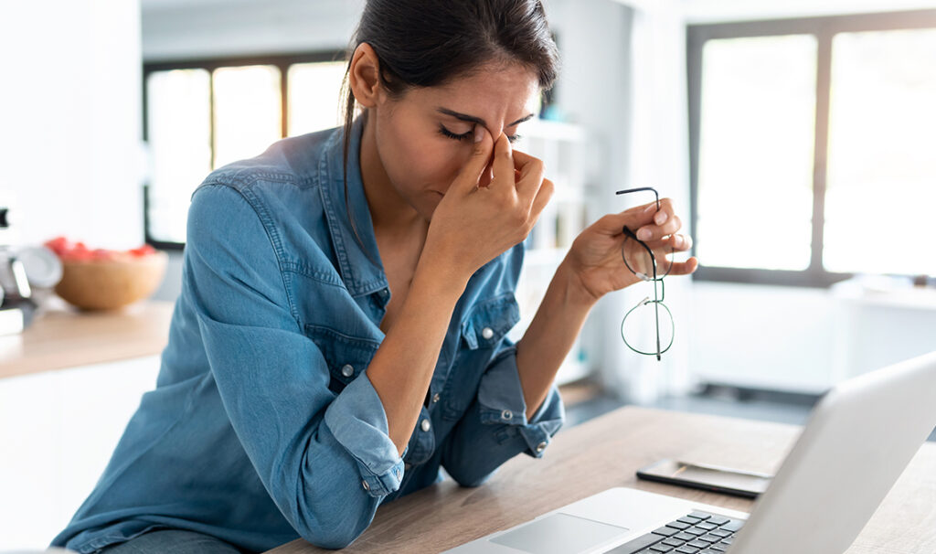 Stressed out woman on laptop.