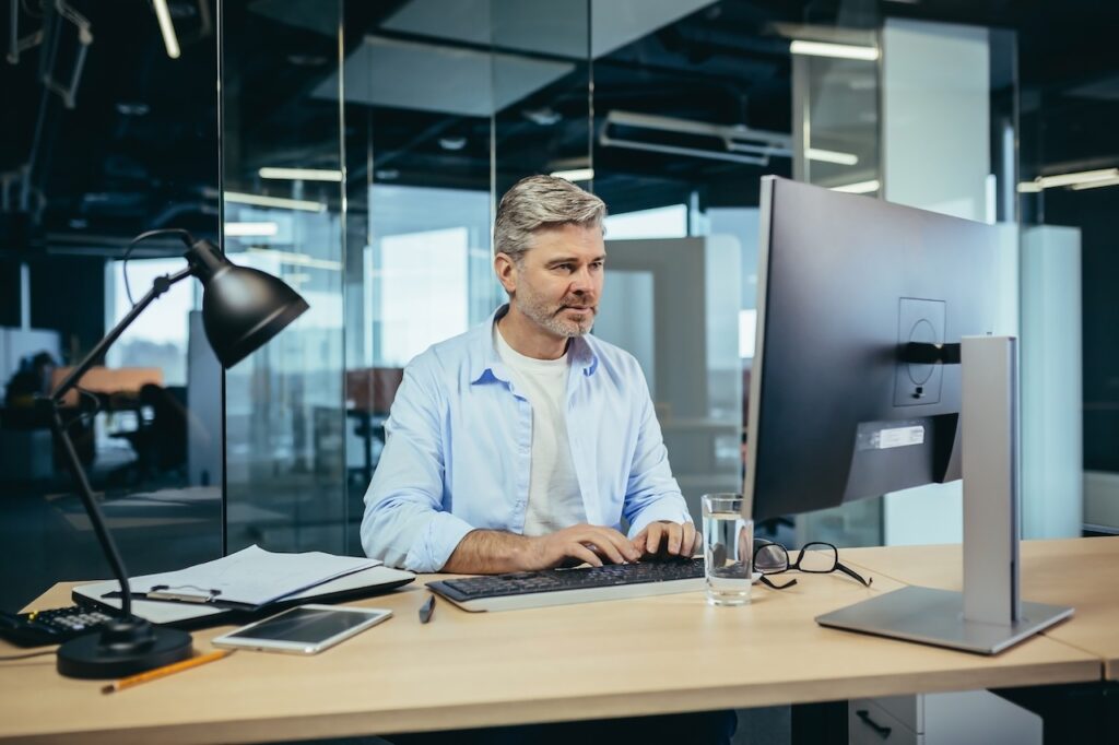 man working on computer in office