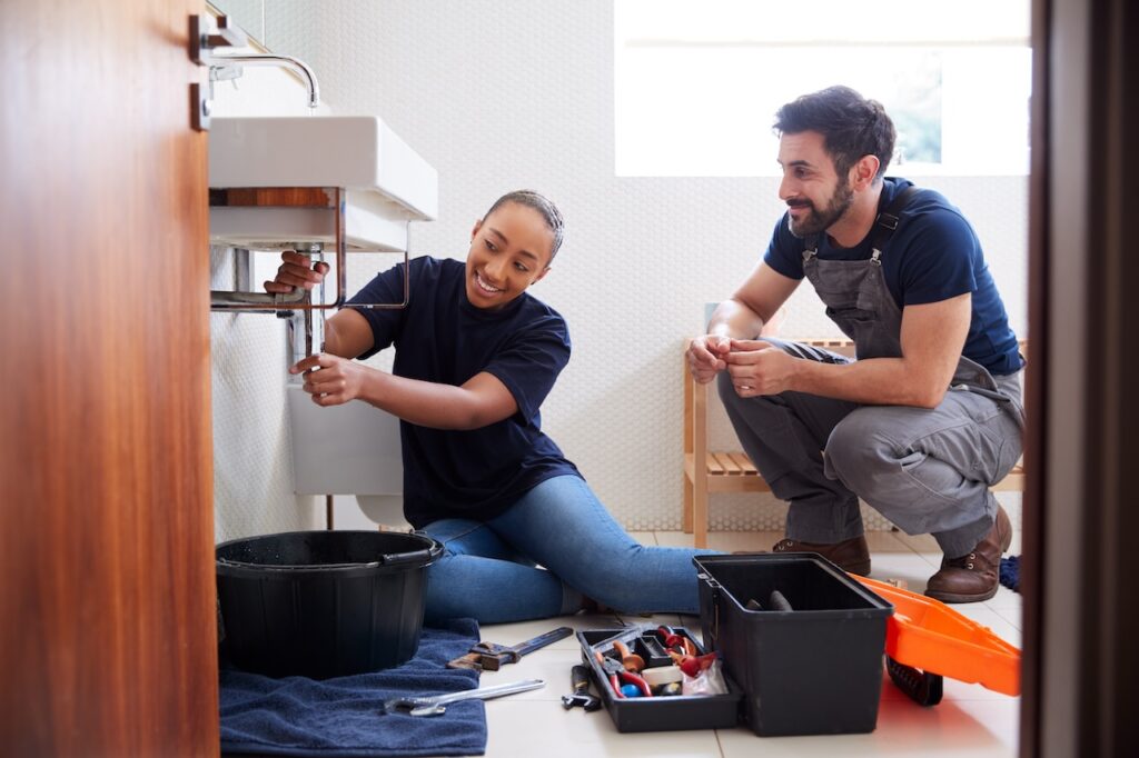 plumbers fixing sink